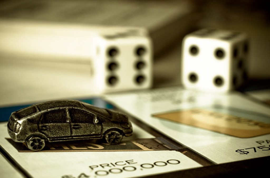 Part of the Monopoly game board and a car figurine