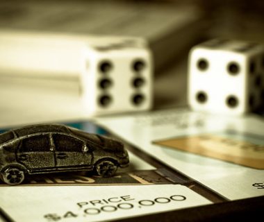 Part of the Monopoly game board and a car figurine