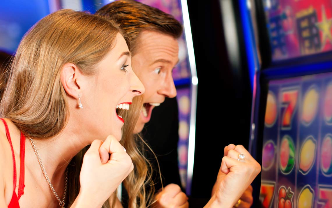 Couple in Casino on a slot machine